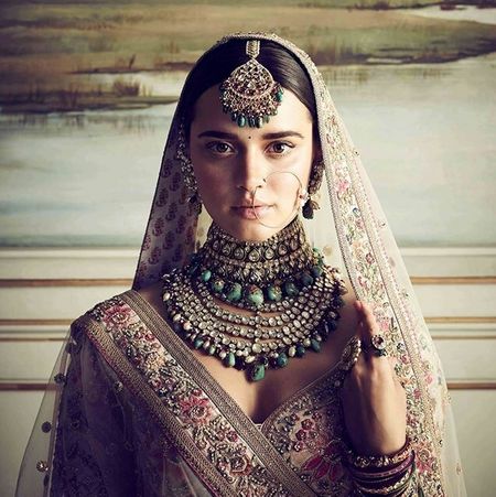 Photo of Sabyasachi bridal jewellery with green beads