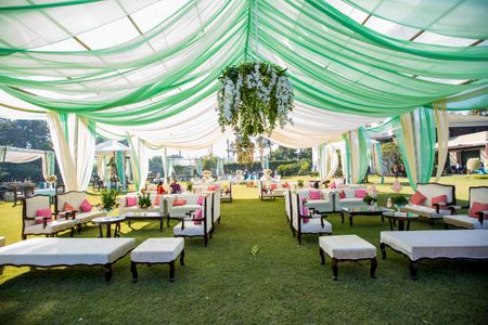 Photo of A green and white indoor tent arrangement.