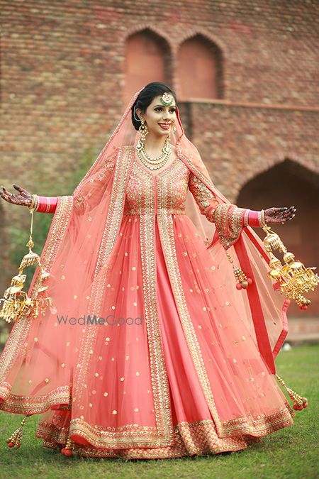 Sikh bride in gold and coral anarkali with kaleere