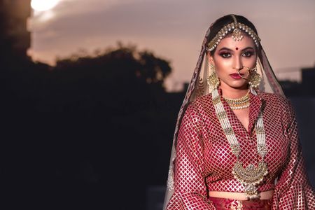 A bride in maroon and vintage jewelry
