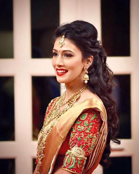 South Indian bride with open hair and embroidered blouse 