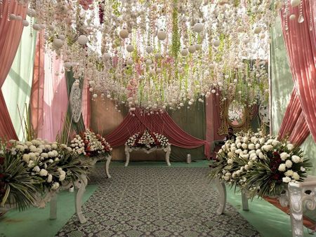 Grand entrance decor with cascading flowers and flowy drapes.