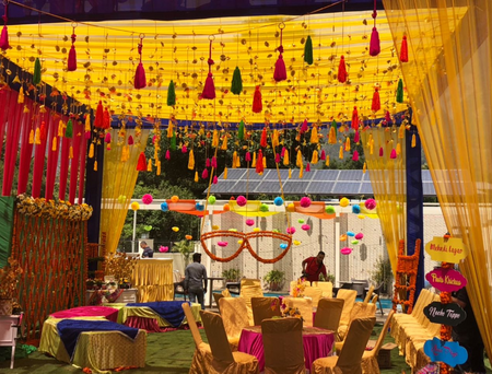 Photo of Colorful mehendi decor with hanging tassels and sunglasses