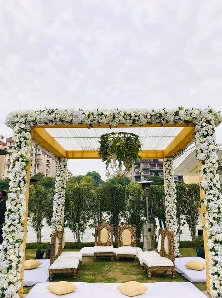 Photo of An open mandap with white flowers