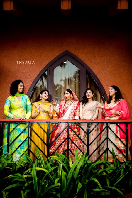 fun shot with brides and bridesmaids in balcony