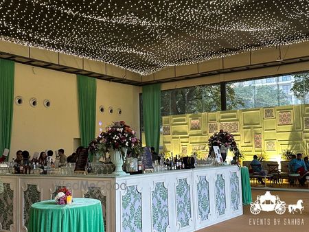 Fun bar set up with floral arrangement and a starry night lights set up