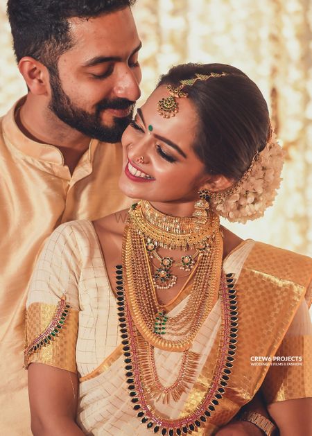 Photo of Matching bride and groom South Indian couple