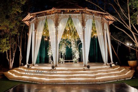 Elegant stage decor with white drapes for a reception event 