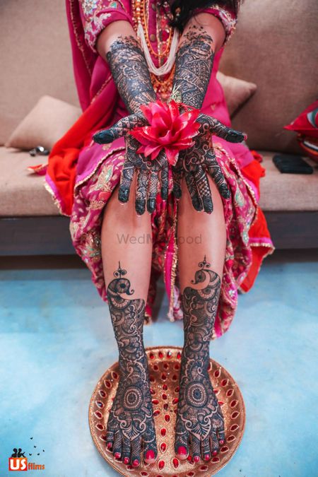 Bridal mehendi on feet and hand with flower