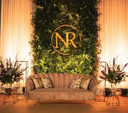 light green and gold couple seating idea with botanical wall