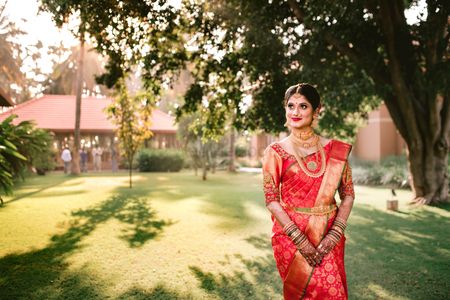 south indian bride in a gold and orange kanjeevaram