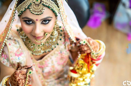 Photo of Pastel bride with contrasting jewellery and kohl eyes