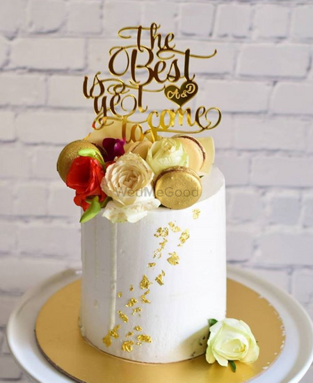 Photo of Pretty fondant cake with golden macrons for wedding