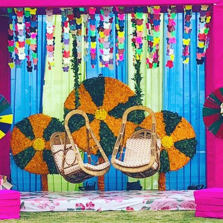 Colorful mehendi decor with swing for the bride 