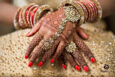 Bridal hands with mehendi and haathphool