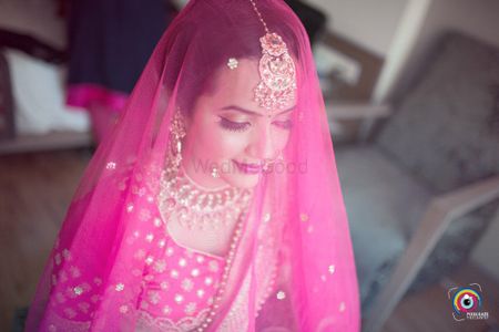Wedding day bridal portrait with dupatta as veil