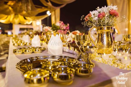 Photo of Gold jugs with flowers in table decor