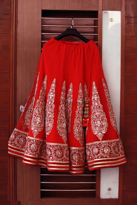 Photo of Red Lehenga with Vertical Motifs on a Hanger