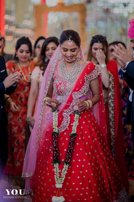 Light pink and red lehenga with scalloped edge