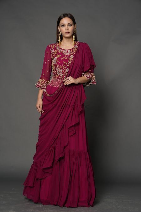A dark pink saree gown with an embellished bodice.