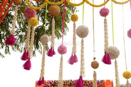 Pretty hanging floral balls with tassels in mehendi decoration 