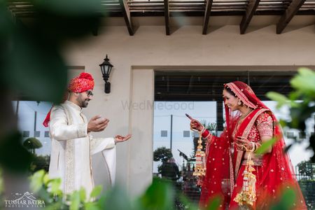 The bride and groom caught in a candid moment on the day of their wedding by Tushar Batra Films.