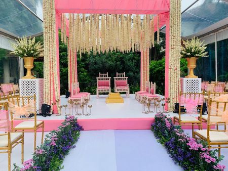 Photo of light pink mandap and aisle with floral strings