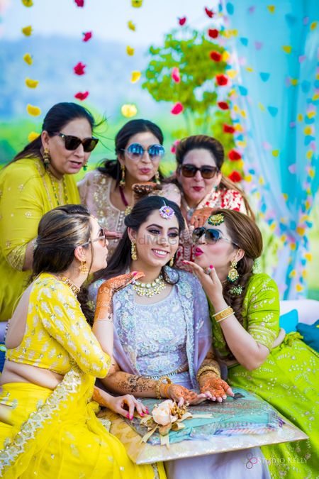 A bride posing with her bridesmaids on her mehndi 
