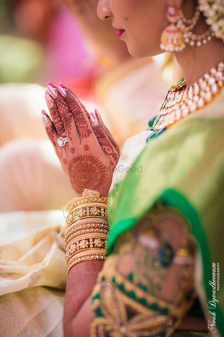 Photo of Bridal hands with mehendi and engagement ring