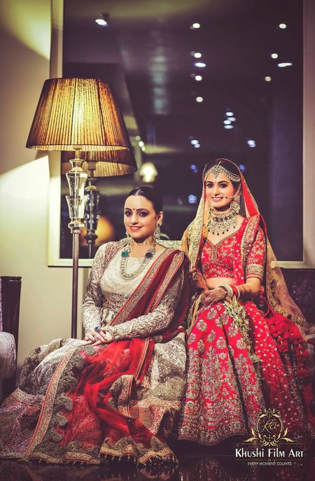 A bride sits with her sister on the wedding day