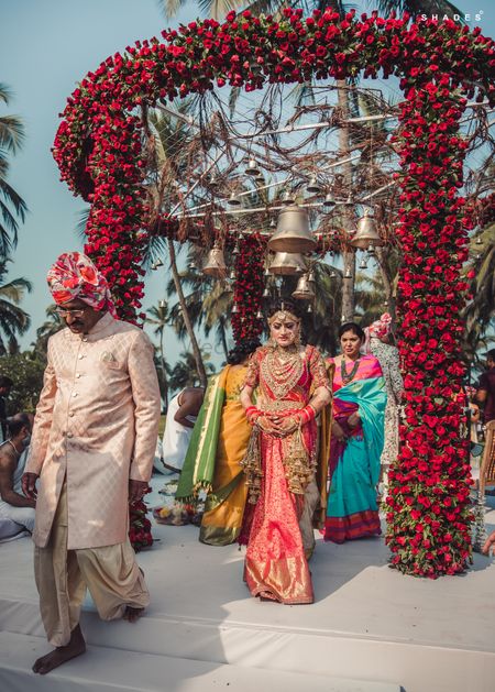 Red floral mandap with temple bells 