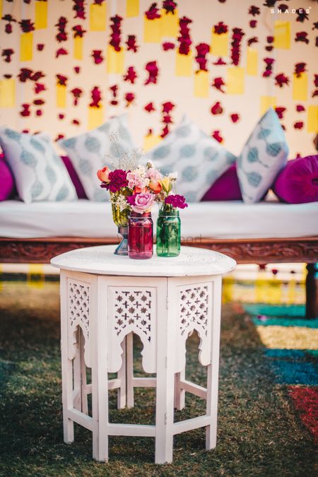 Photo of Mehndi decor idea with a small table and mason jars