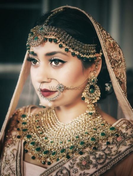 An indian bride wearing polki and jadau jewellery for her wedding