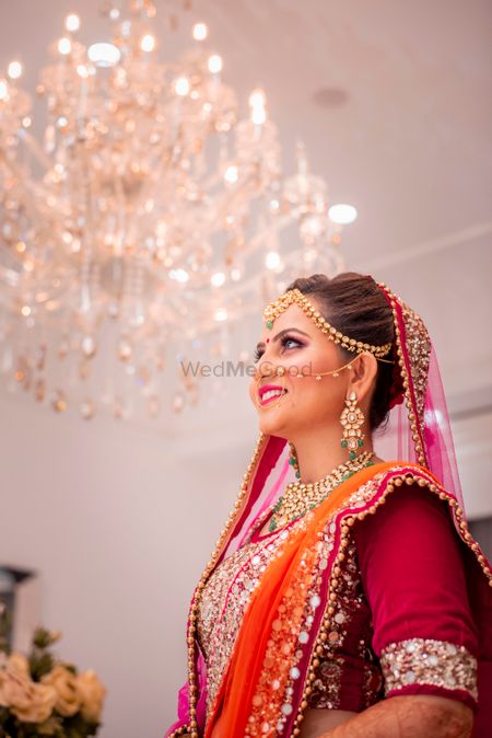 Photo of Happy glowing bride shot in orange lehenga