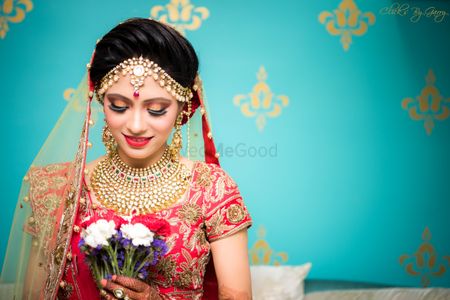 Shy bridal portrait with bride holding flowers