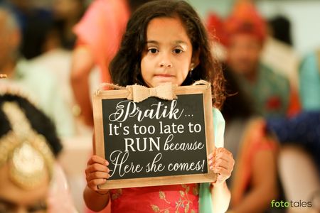 Kids at weddings holding signages during bridal entry.