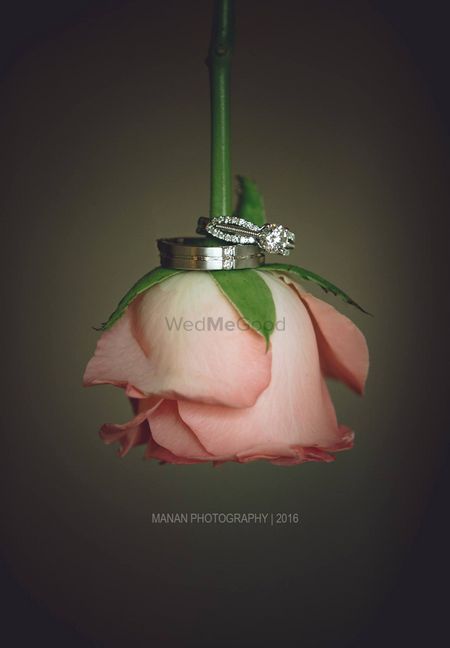 Engagement ring photography idea with a rose
