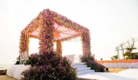 An open mandap with pink floral decor