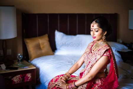 Photo of Bridal portrait with bride wearing red lehenga