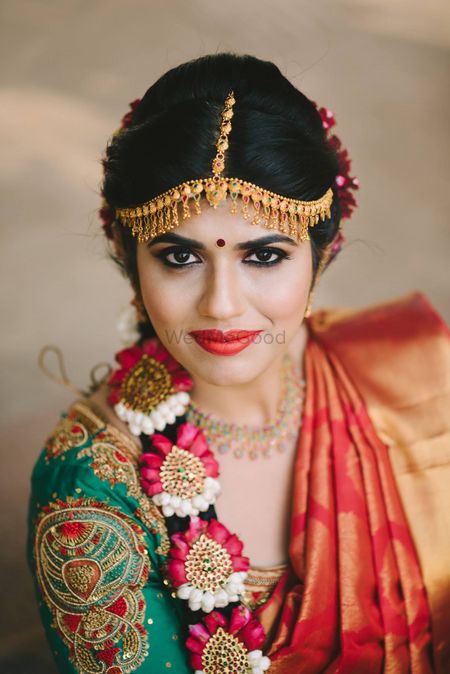 Bride with South Indian blouse design embroidered 