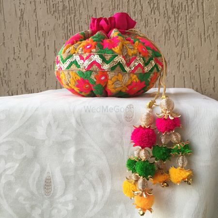 Colourful potli for mehendi with hanging pompoms