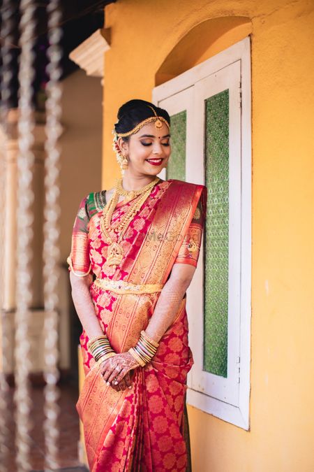 A south Indian bride in a kanjeevaram saree and gold jewelry for her wedding day