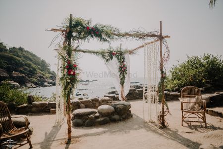 Open mandap with rustic touches and pretty floral arrangements.