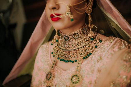 Photo of Bridal choker with green with a pastel lehenga
