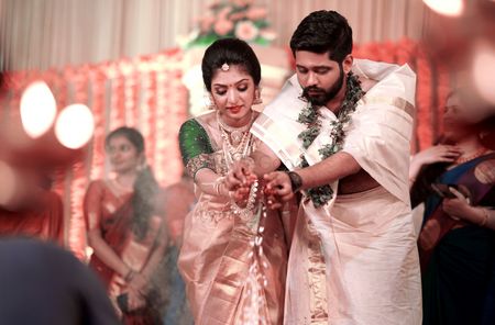 A south indian bride in a gold kanjeevaram performing wedding rituals with the groom