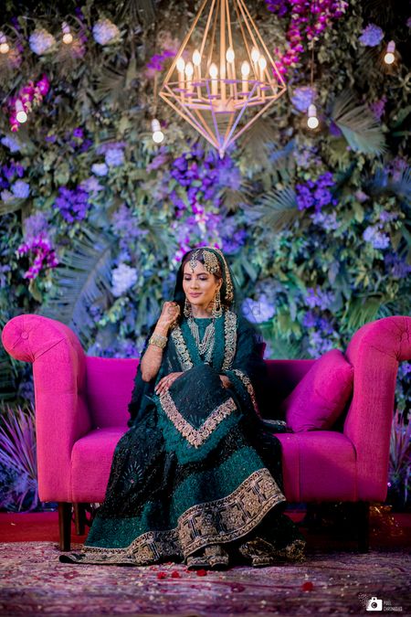 A lovely bride in a stunning teal coloured sharara and gold jewellery.  