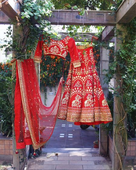 Bright Red Lehenga with Mirror Work on a Hanger