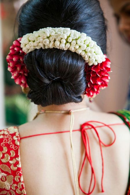 Bridal bun with red and white flowers around