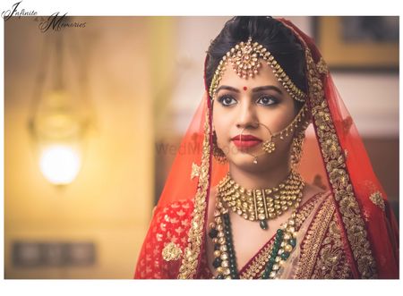 Photo of Red Lehenga with Gold Border and Gold Mathapatti