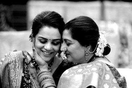 A cute candid shot of a bride with her mother. 